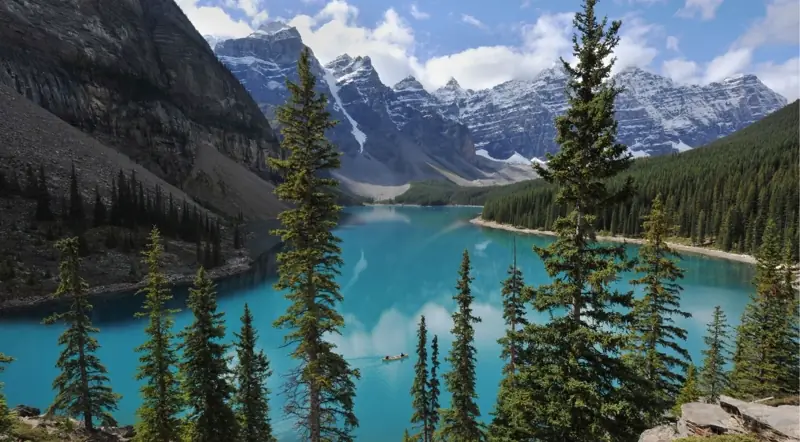 Moraine Lake framed by pines and snow-dusted peaks in the Canadian Rockies